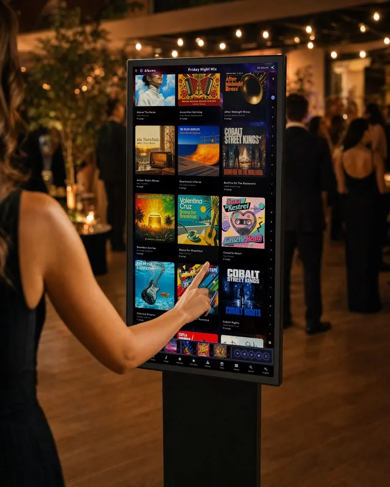 A guest taps a cover on a standing screen at a party